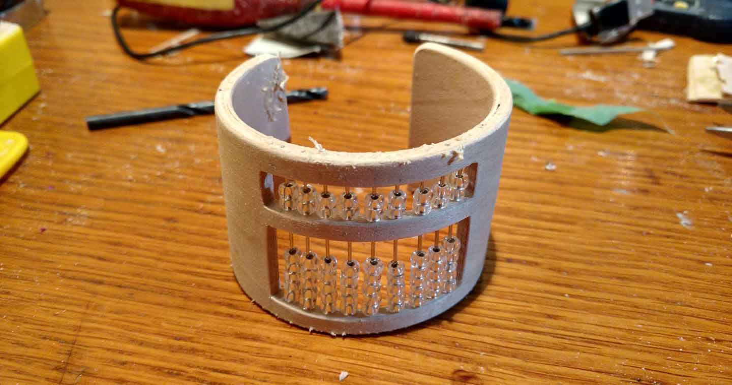 Unstained laminated wood bracelet with wood filler applied to the holes