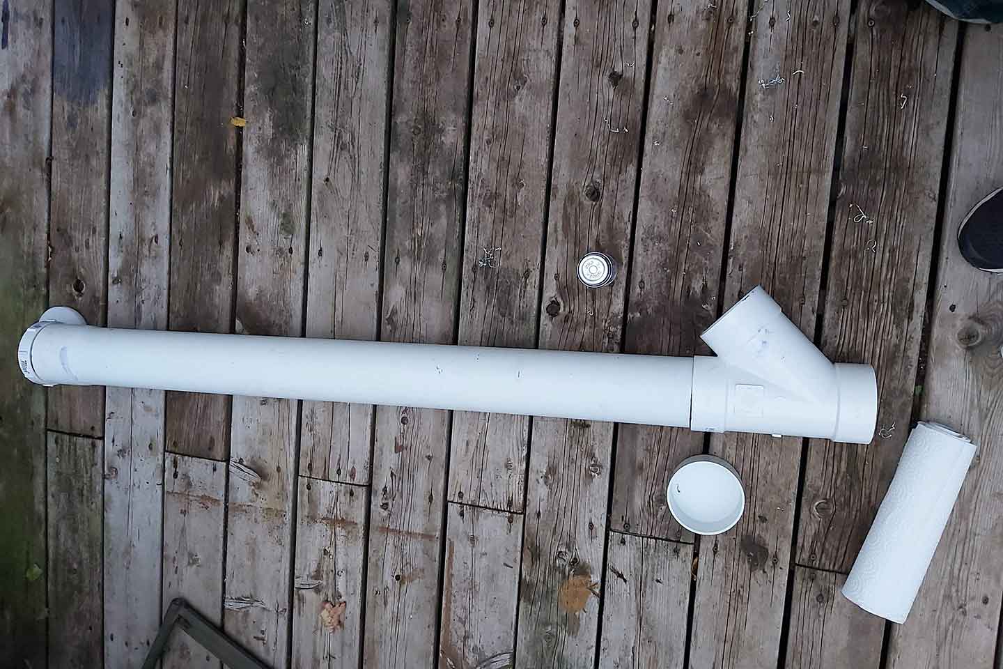 White chicken feeder assembled out of 4 inch sewer pipe